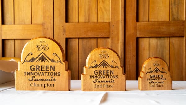 Three Green Innovation Summit 2025 trophies on display